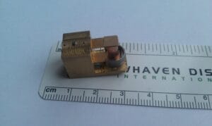 Assembled 1D resonant actuator prototype for a portable OCT system shown against a metric scale