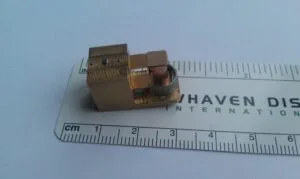 Assembled 1D resonant actuator prototype for a portable OCT system shown against a metric scale